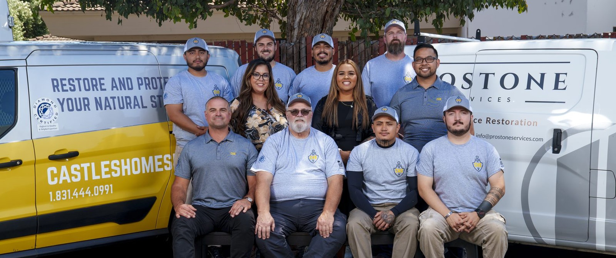 The CHS Restore team standing in front of the company vans